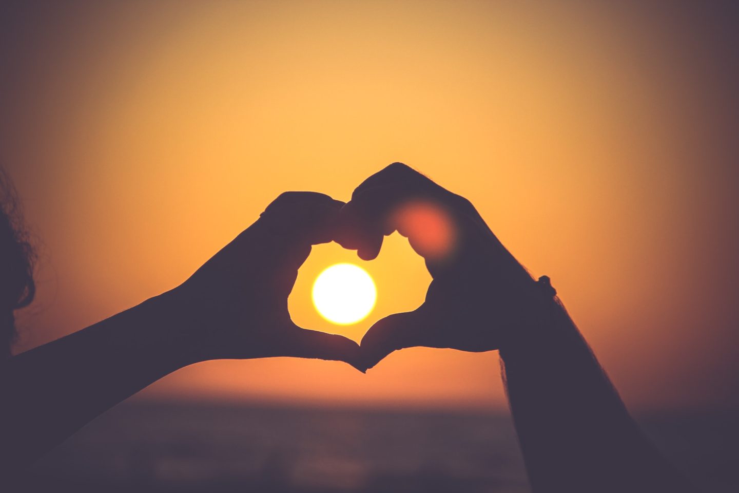 Love Hashtags - Picture of hands making heart around the sun
